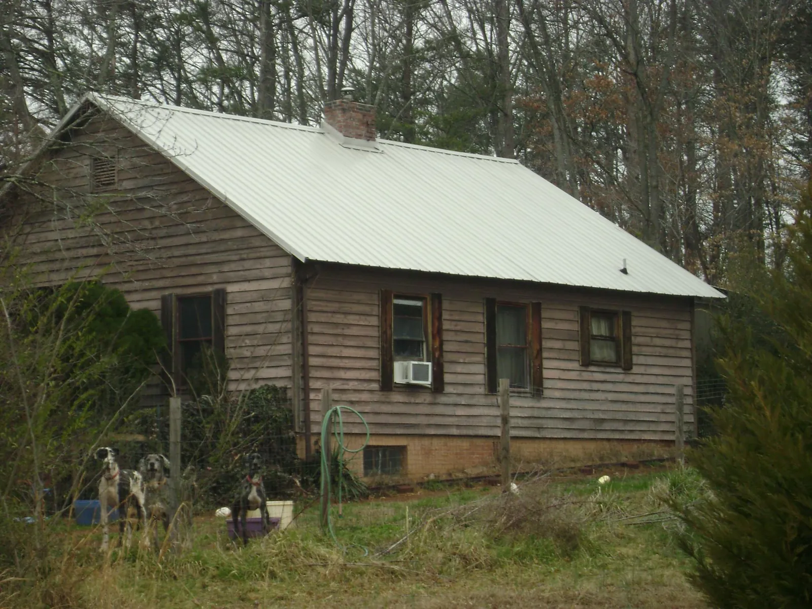 White metal roof on an old wood sided farmhouse, from a Metal Roof Installation job in Lucerne